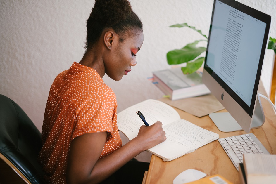 A woman writing in her notebook